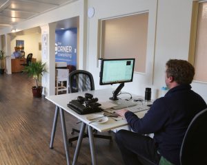 Member working at shared open workspace at The Corner Coworking