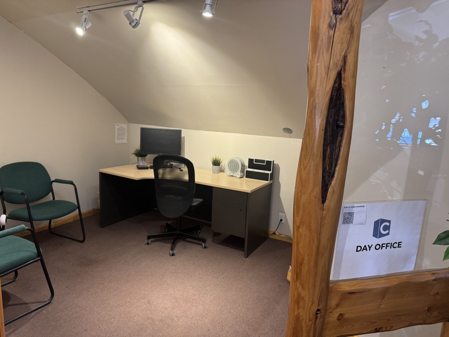 Day Office workspace with desk, monitor, and seating at The Corner Coworking Railway St
